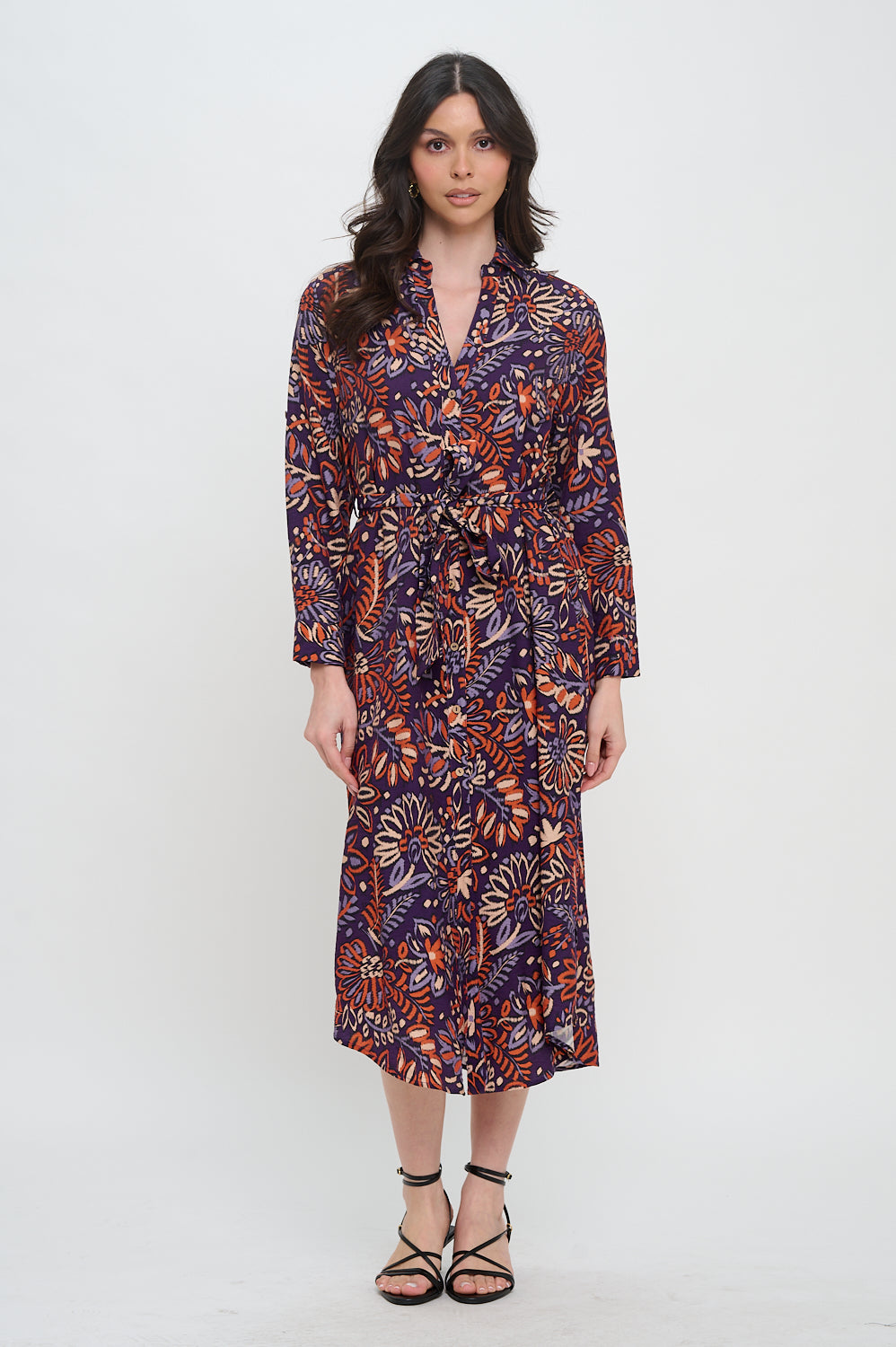 Model wearing collared button-down midi shirt dress in ikat floral print with waist tie