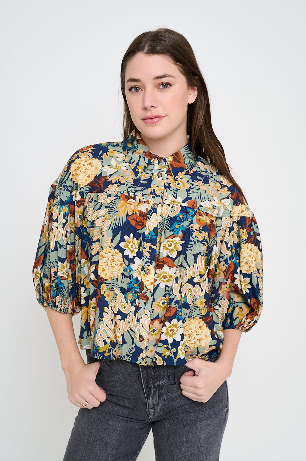 Model wearing floral print button-up blouse with puff sleeves and collared neckline
