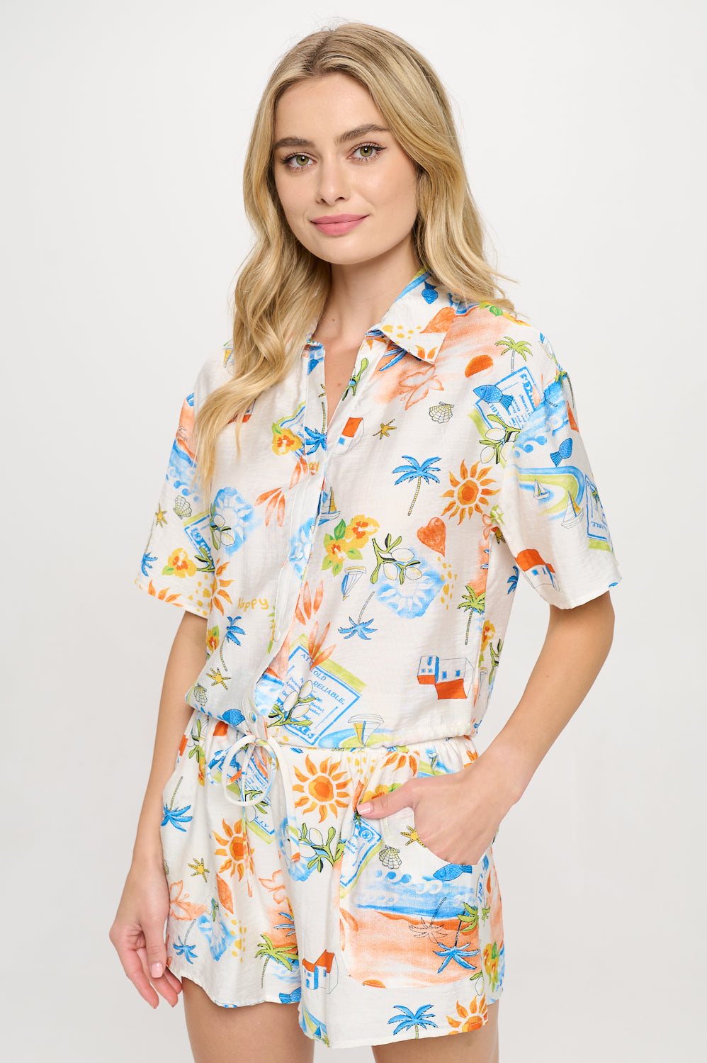 Model wearing Mediterranean Daydream Set – matching printed button-down shirt and drawstring shorts with a coastal-inspired print.