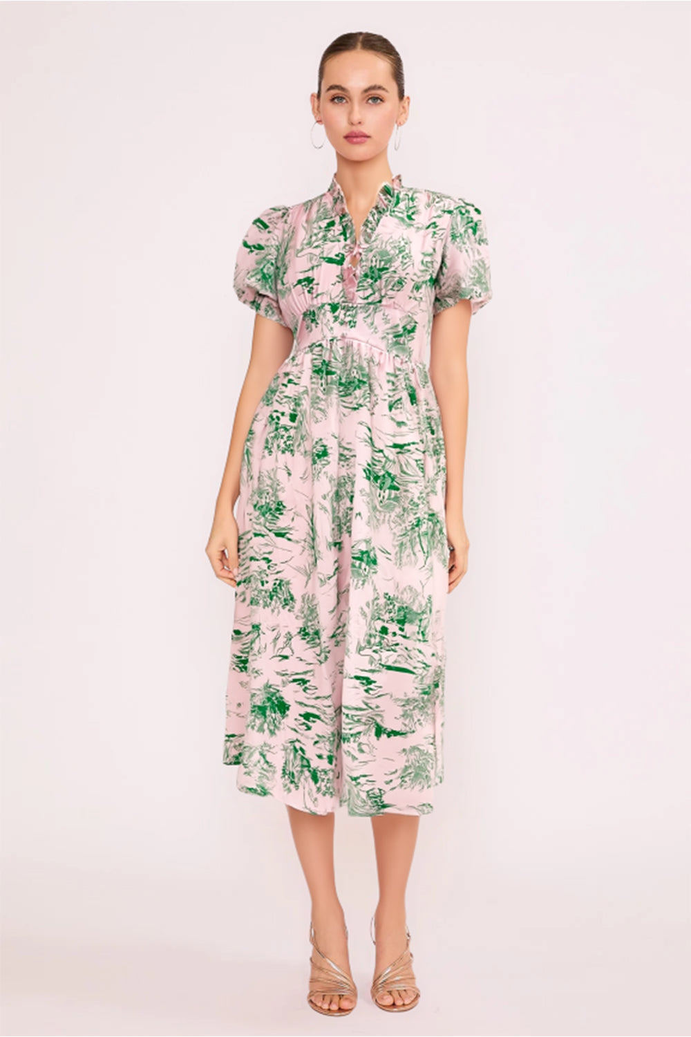 Model wearing the Garden Reverie Maxi Dress with puff sleeves and green botanical print on a soft pink base.
