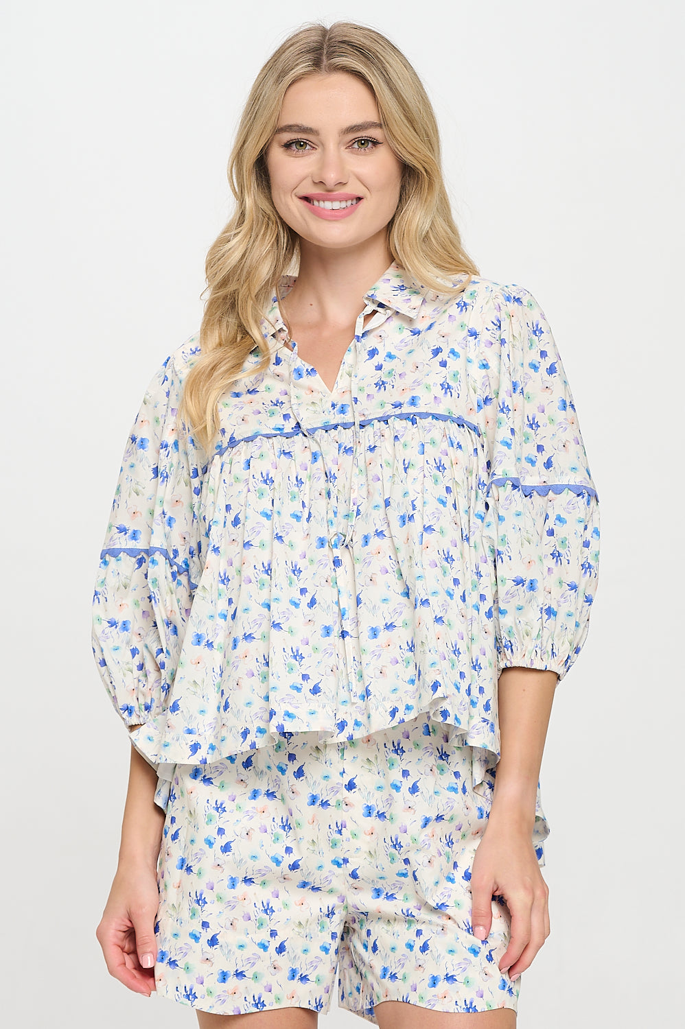 Lightweight floral blouse with lace trim, pintuck details, and flowy silhouette—perfect for spring layering or easy resort-ready looks.