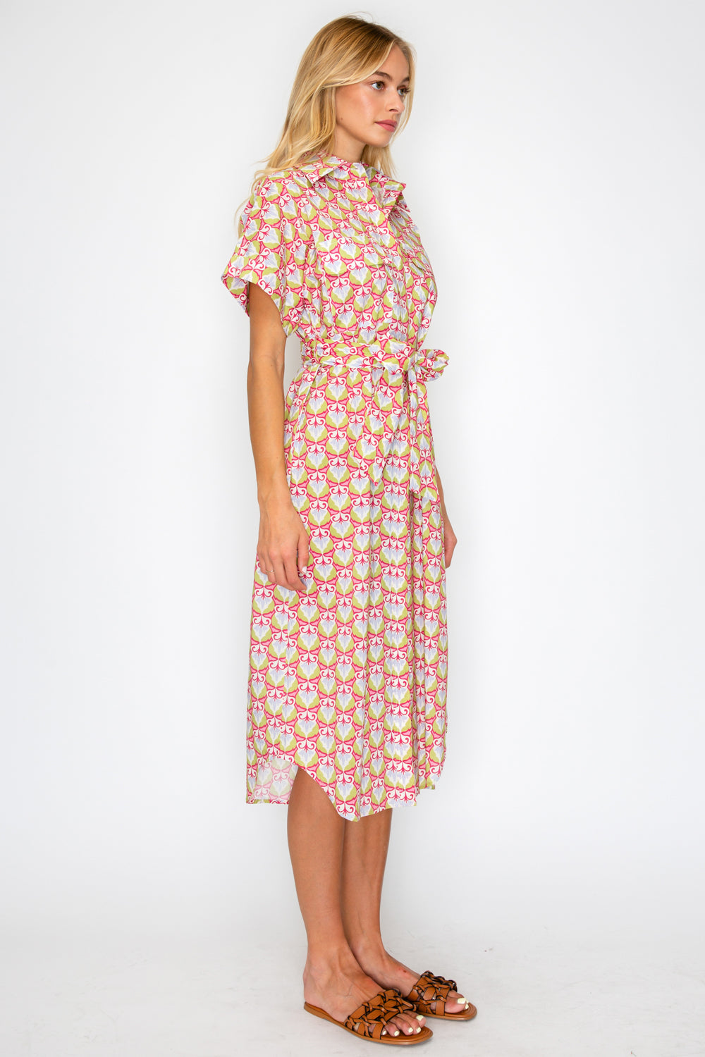 Woman wearing a patterned dress on a white background