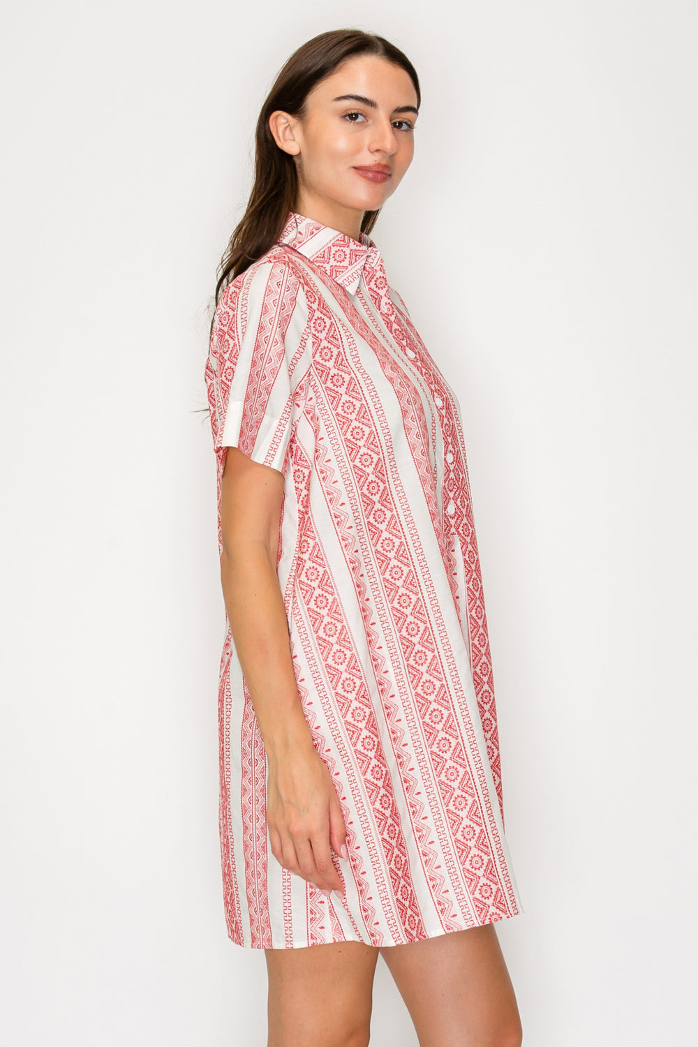 Woman wearing a red and white patterned dress on a white background
