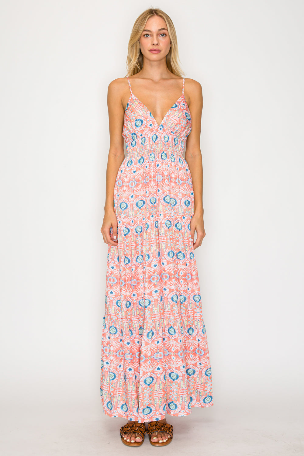 Woman wearing a floral patterned dress on a white background