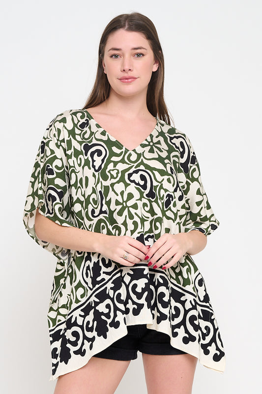 Model wearing Olive Scroll Tunic Top with V-neckline and handkerchief hem in abstract print