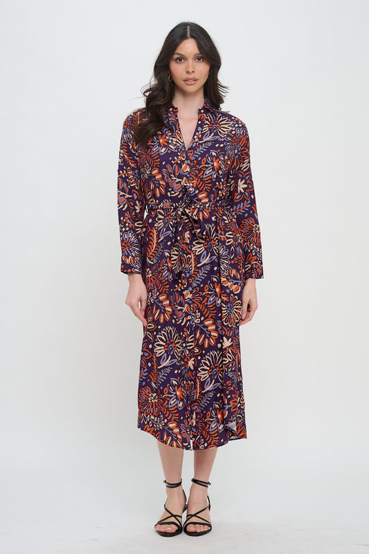 Model wearing collared button-down midi shirt dress in ikat floral print with waist tie