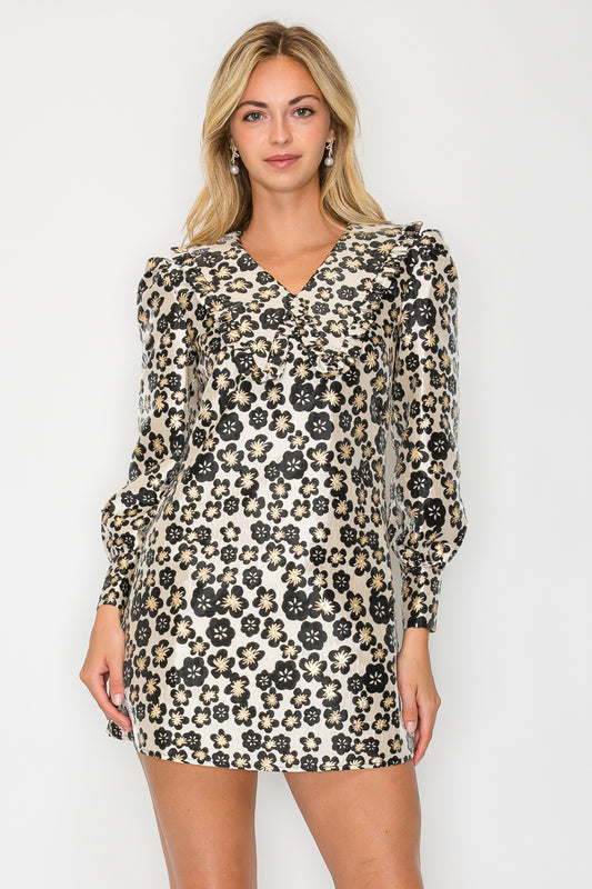 Model wearing the Black Jacquard Collared Dress, a metallic floral mini dress with a statement collar and long puff sleeves.
