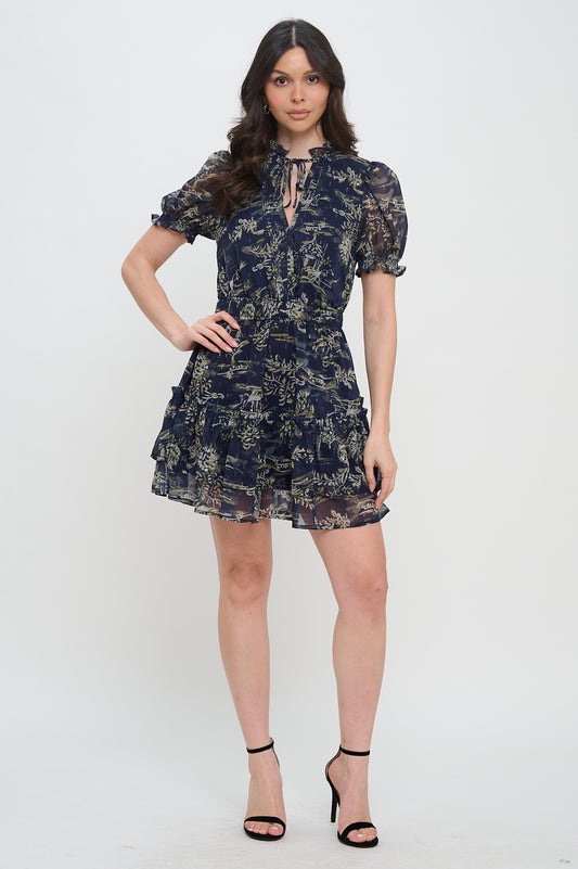 Model wearing floral chiffon mini dress with puff sleeves and tie neckline