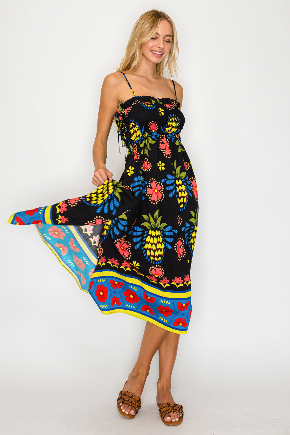 Woman wearing a colorful floral dress with a white background