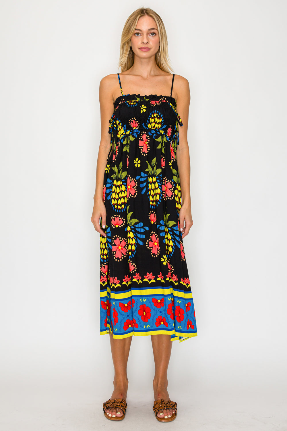 Woman wearing a colorful floral dress on a white background