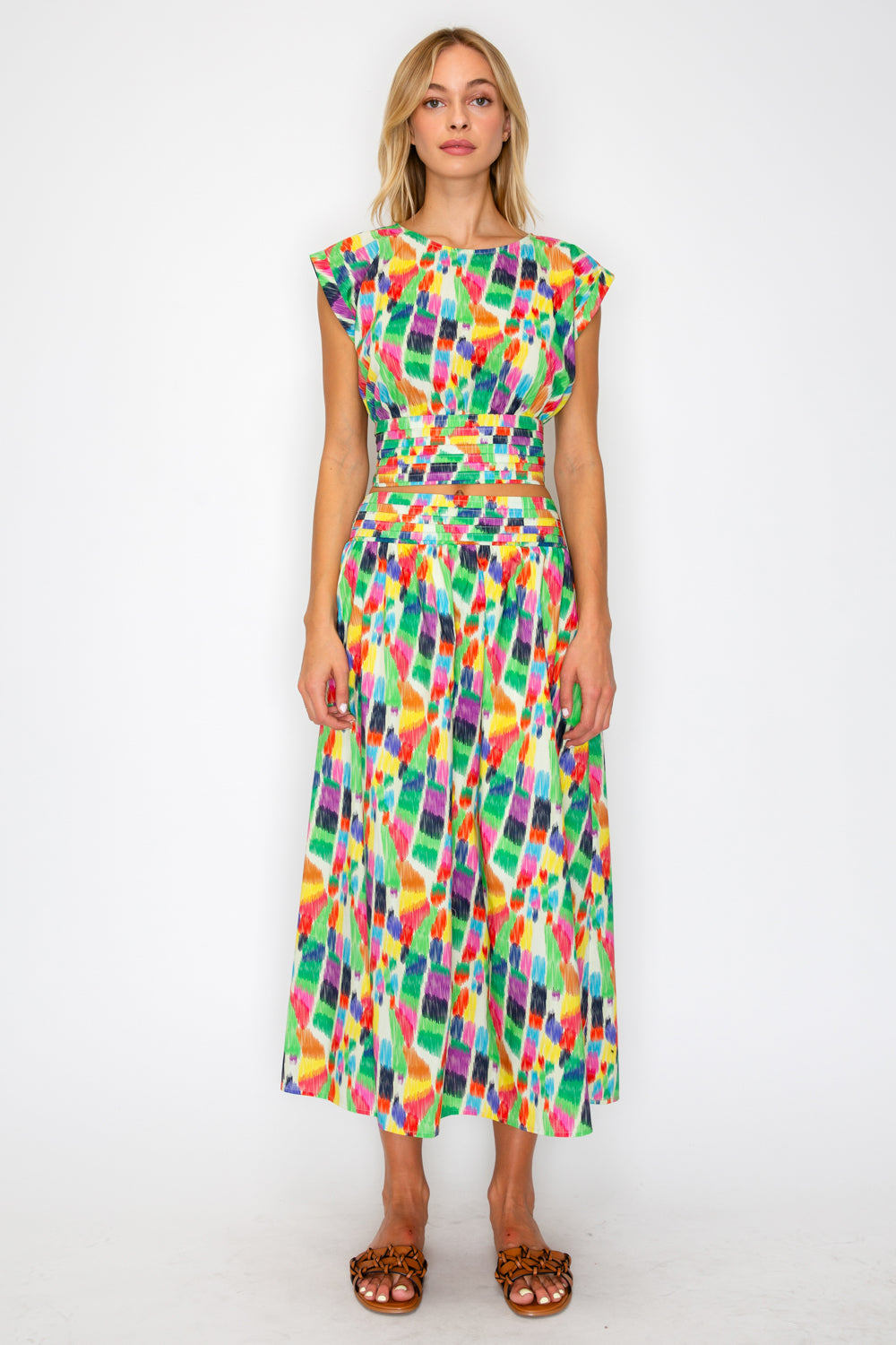 Woman wearing a colorful patterned dress on a white background