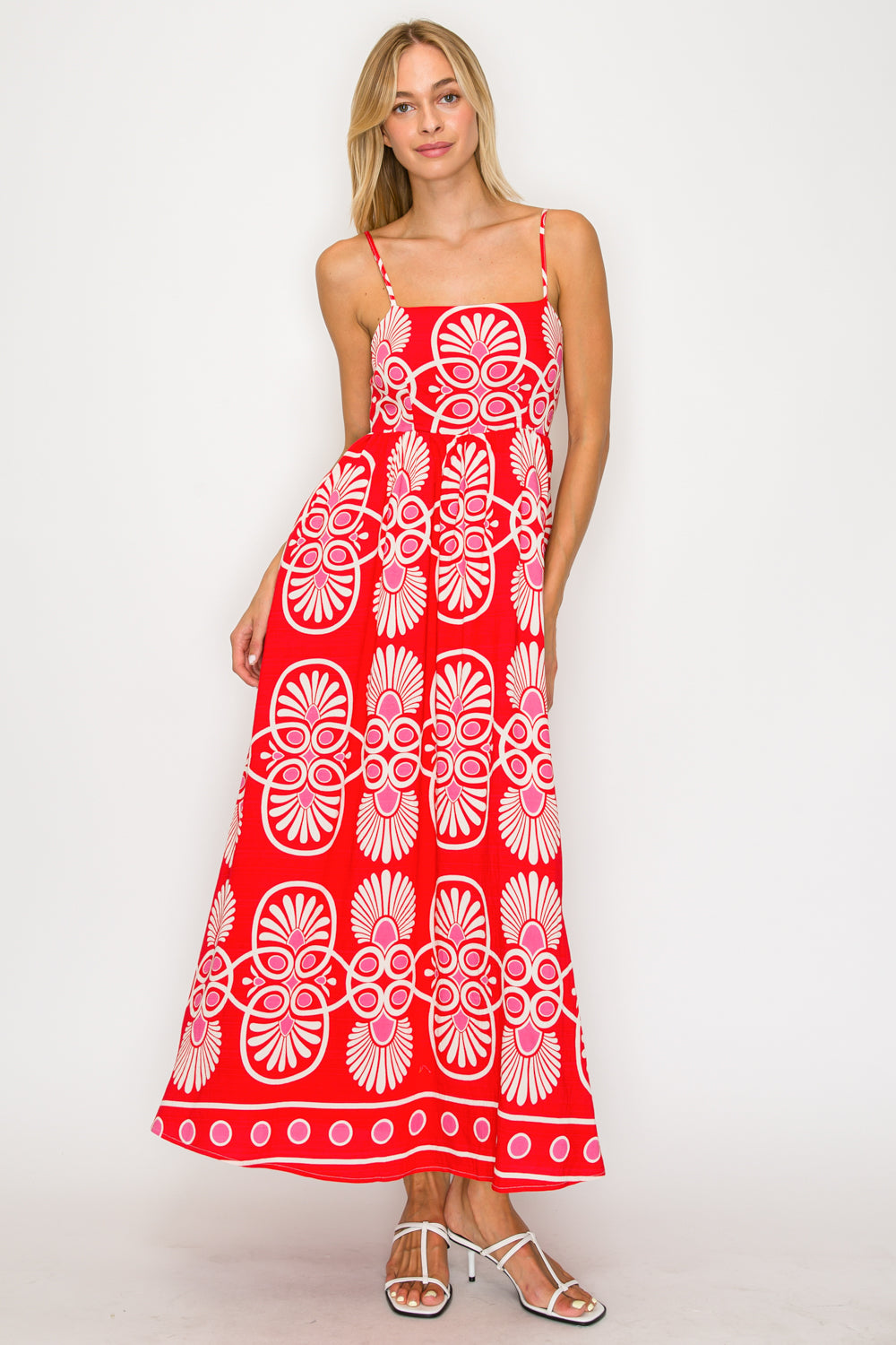 Woman wearing a red and white patterned dress on a white background