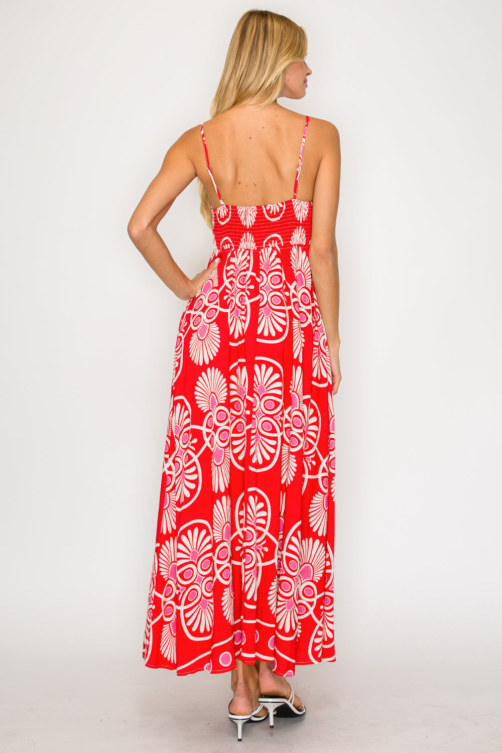 Woman wearing a red floral dress on a white background
