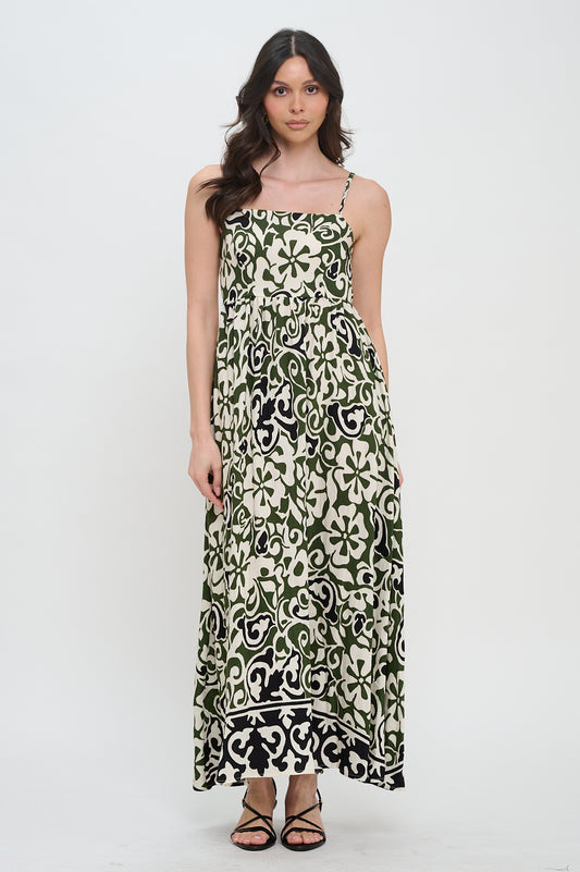 Model wearing olive scroll print maxi dress with spaghetti straps and contrast hem