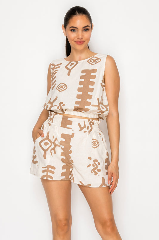 Model wearing the Santorini Sunplay Set, a cream and brown printed sleeveless top and matching high-waisted shorts.