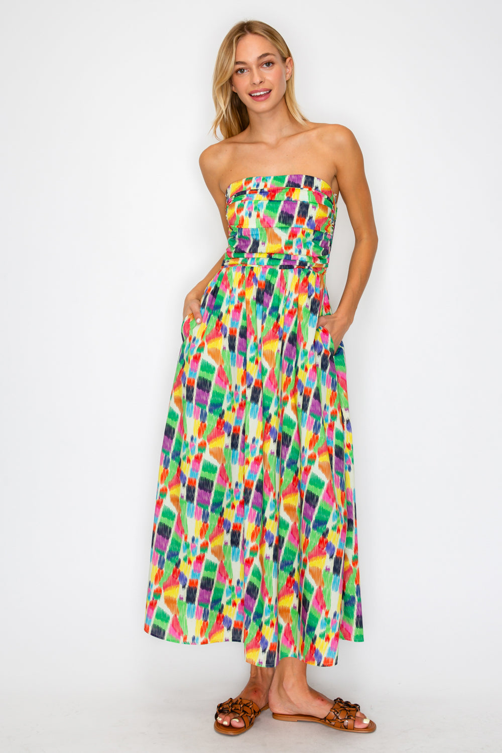 Woman wearing a colorful strapless dress on a white background