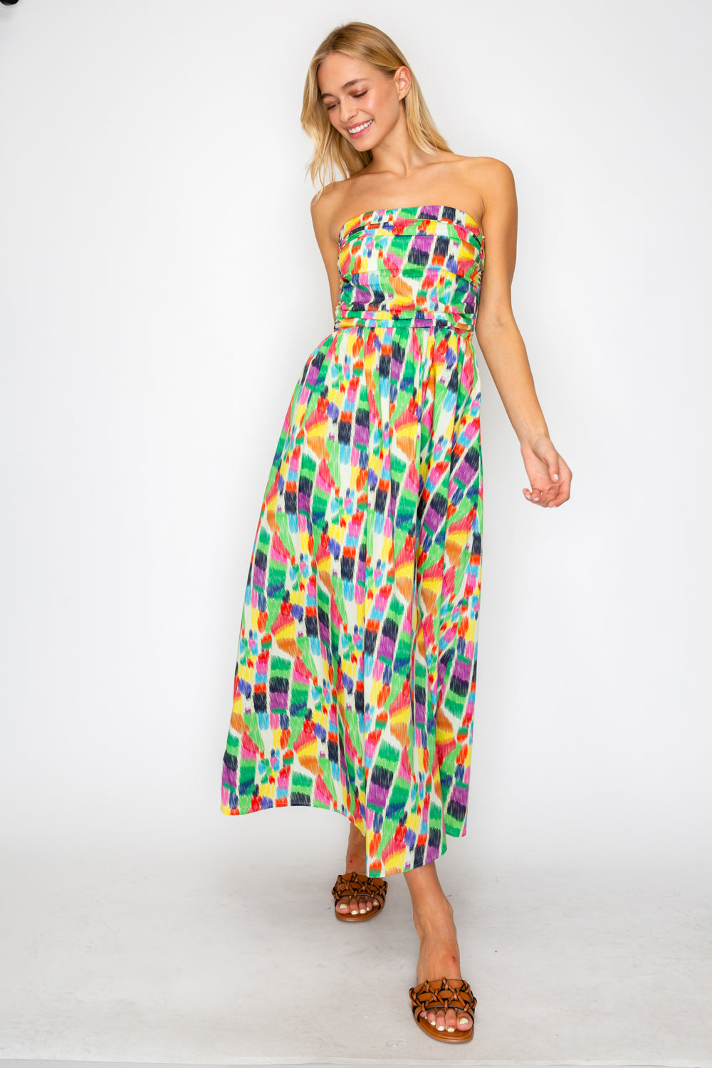 Woman wearing a colorful strapless dress on a white background