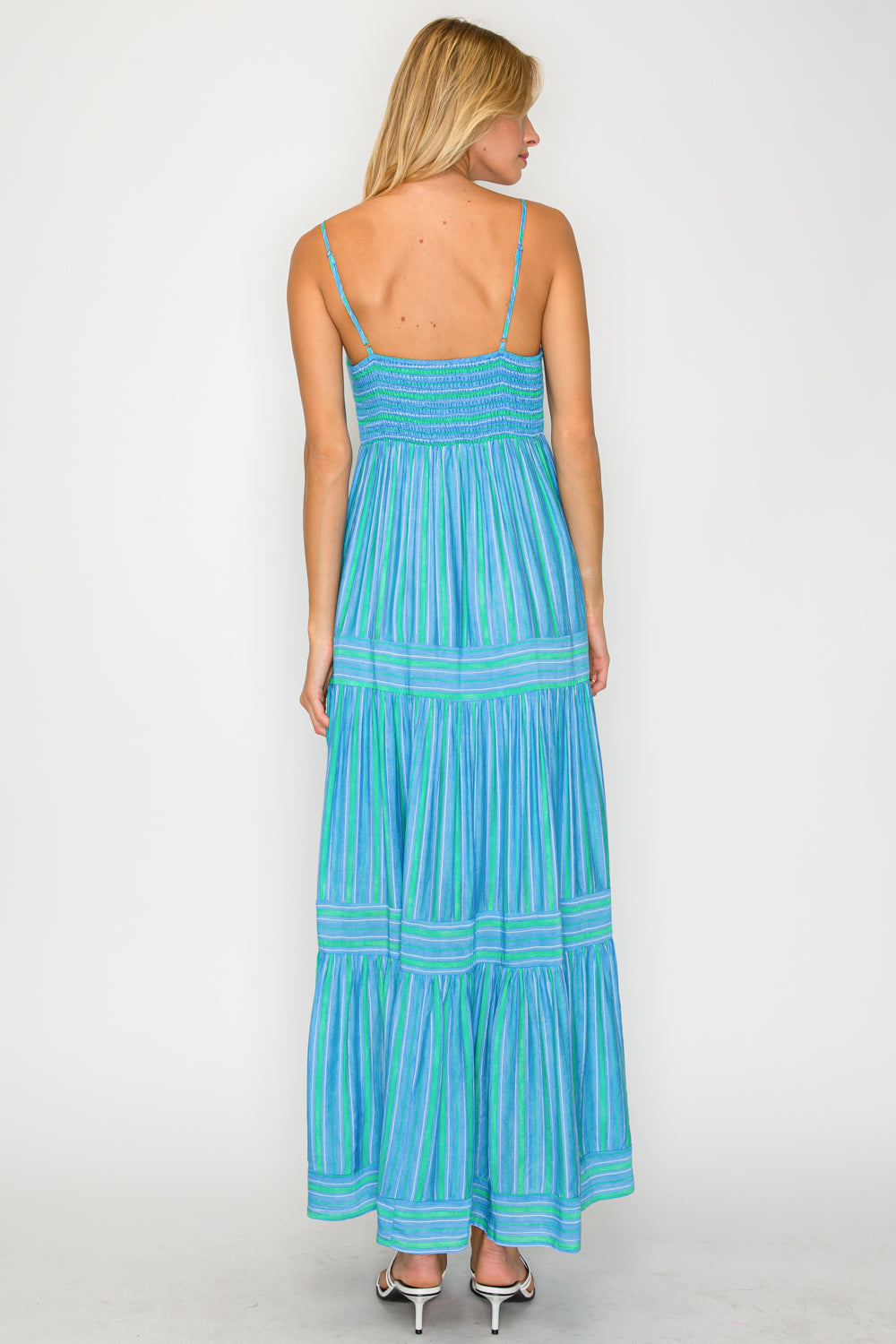 Woman wearing a blue striped dress on a white background