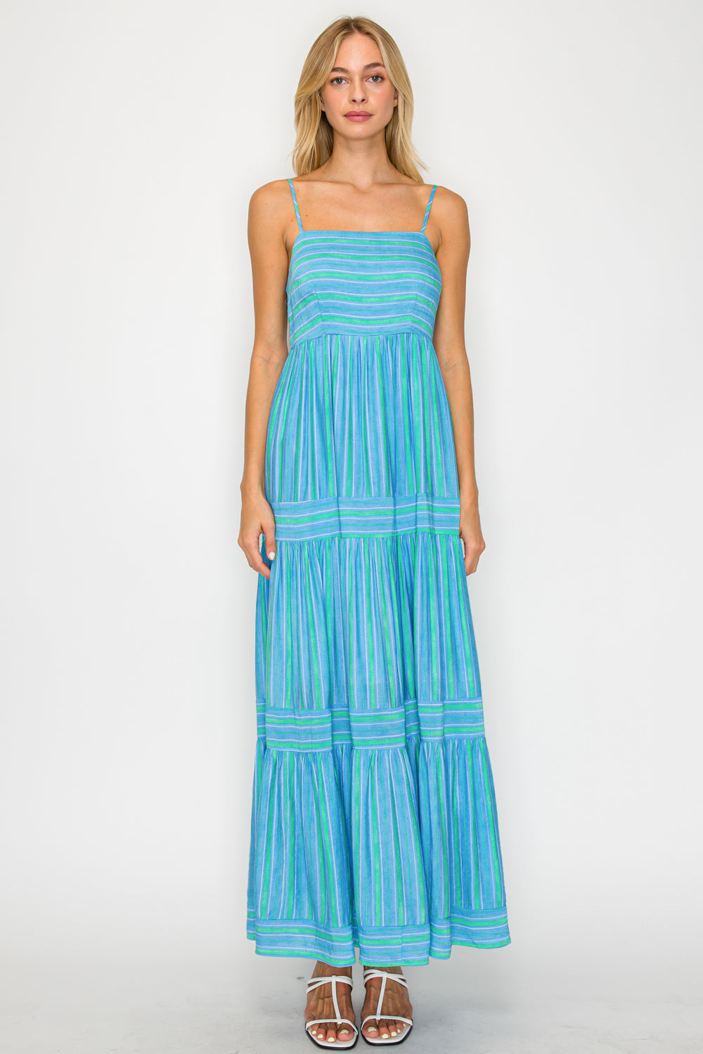 Woman wearing a blue striped dress on a white background
