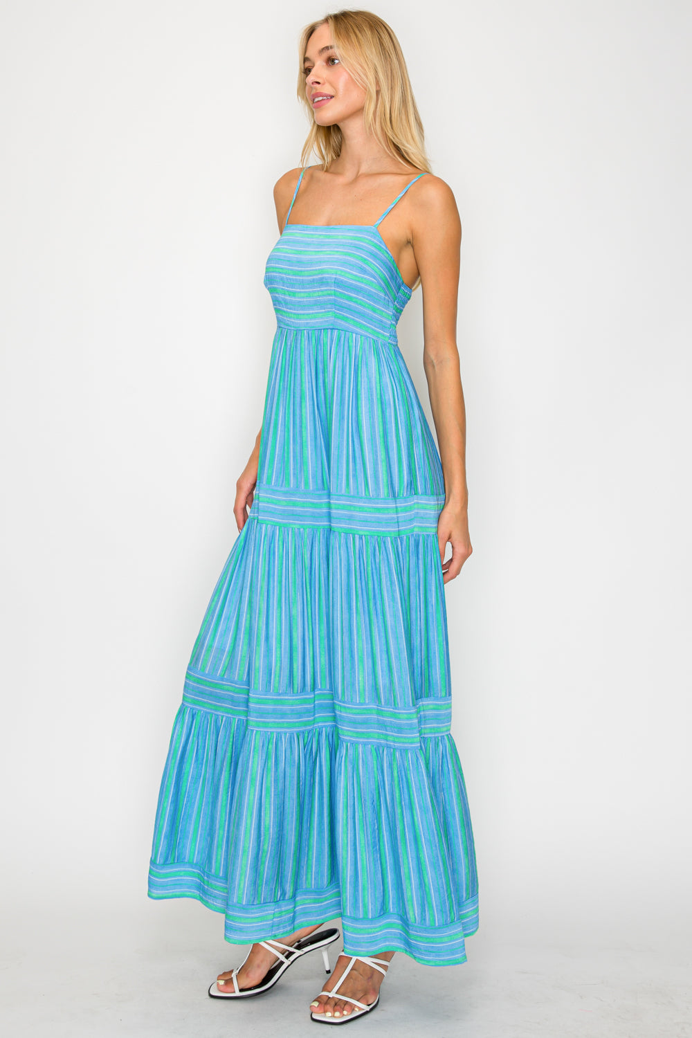 Woman wearing a blue striped dress on a white background