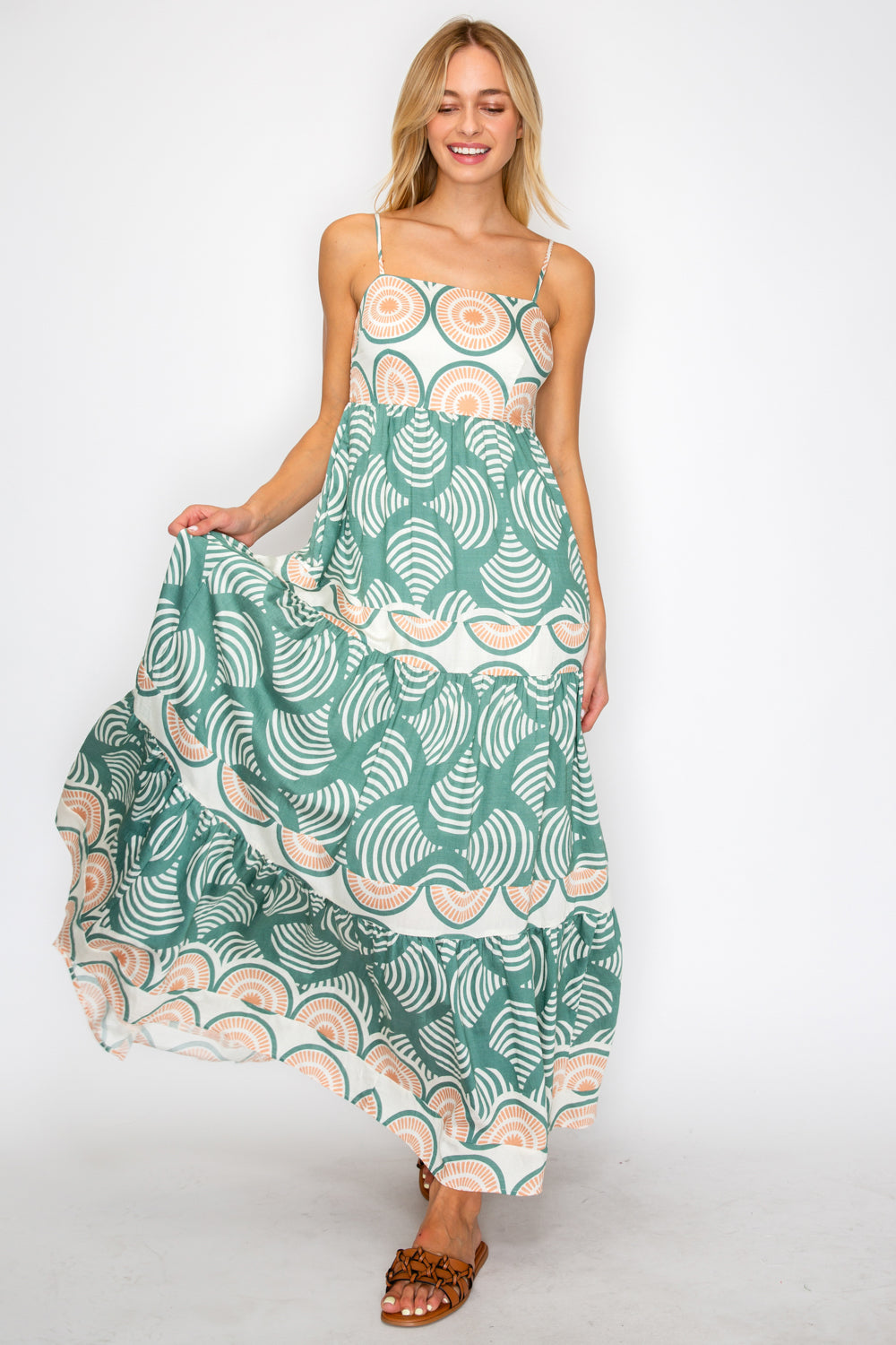 Woman wearing a green and white patterned dress on a white background