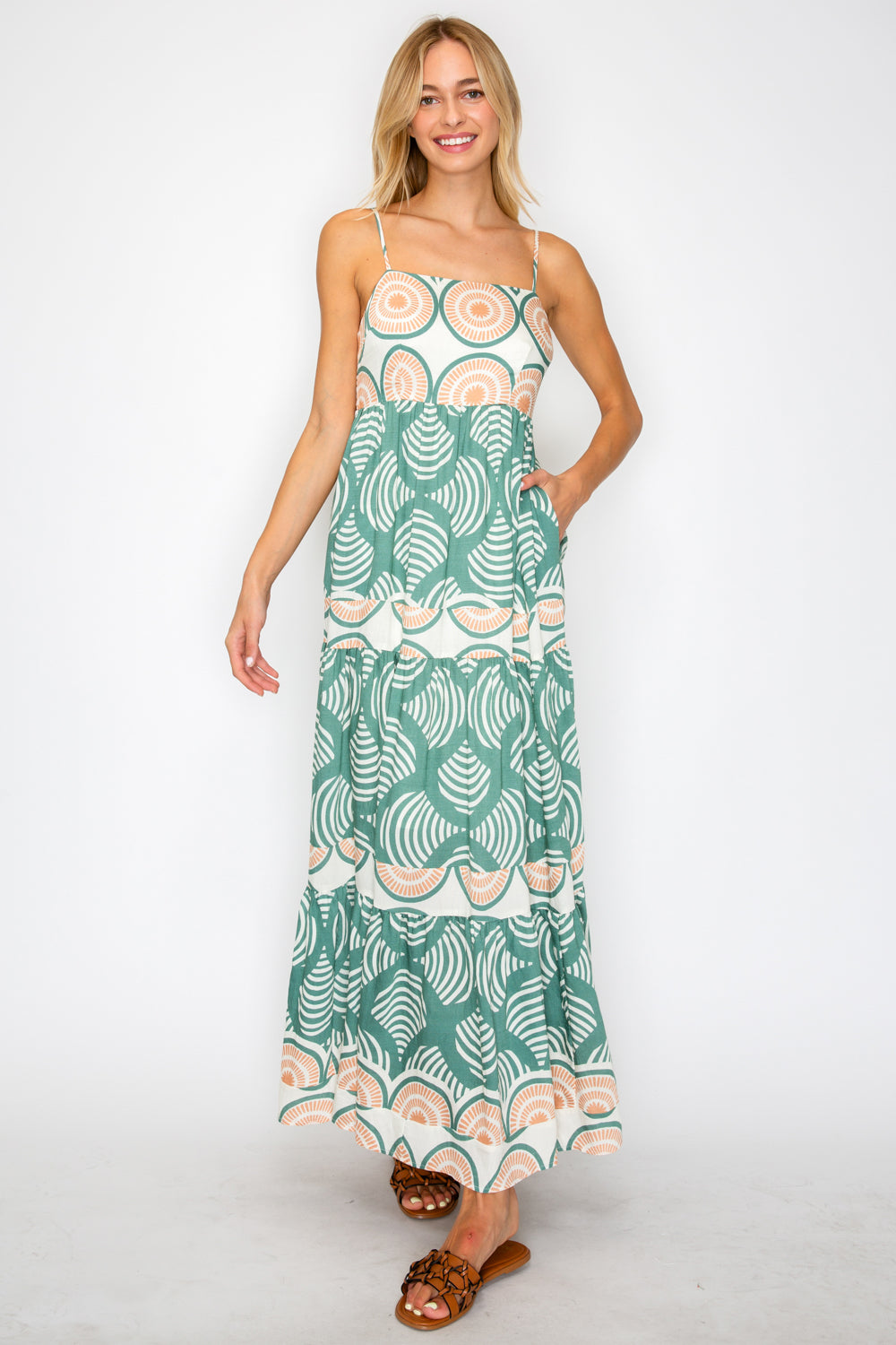 Woman wearing a patterned dress on a white background