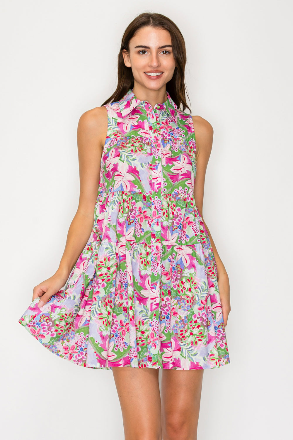 Woman wearing a colorful floral dress against a white background
