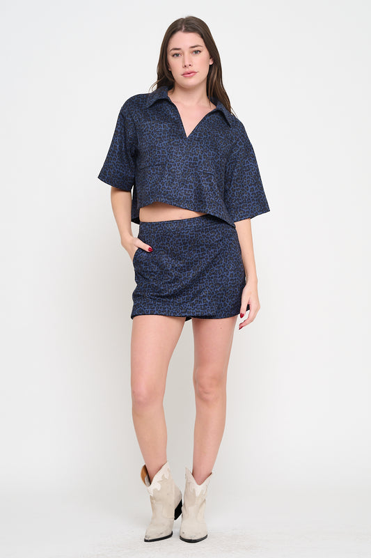 Model wearing a cropped animal print collared shirt with short sleeves and relaxed fit