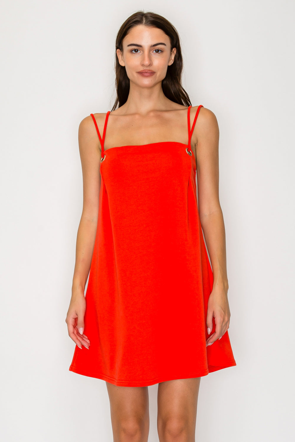 Woman wearing a bright red dress against a white background