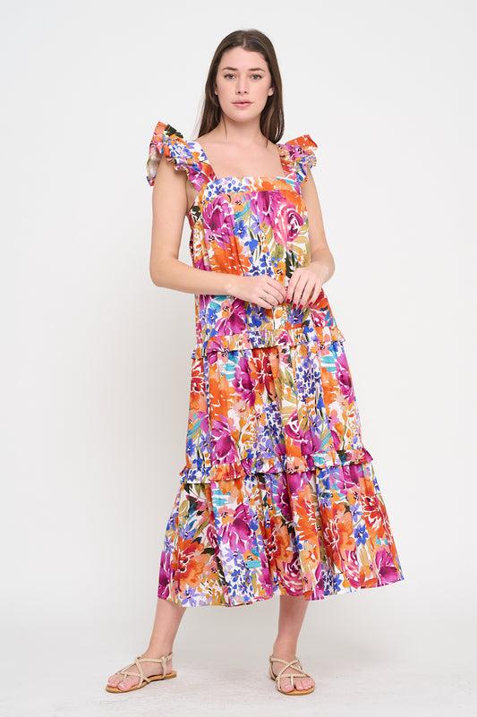 Model wearing a colorful Fall Fiesta Ruffle Maxi Dress with tiered skirt and ruffle straps, styled for a resort-ready look.