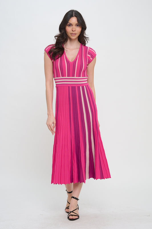 Model wearing a ribbed midi dress with multicolor vertical stripes in pink tones, featuring cap sleeves, a V-neckline, and a fitted waistband.