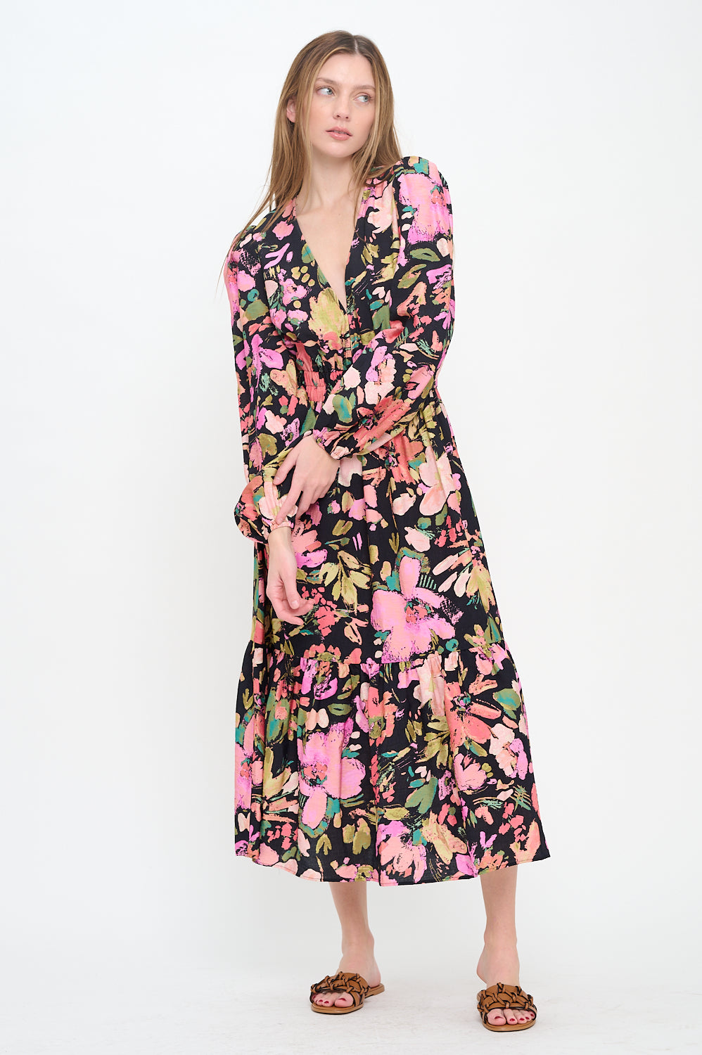 Model wearing the Midnight Garden Long Sleeve Maxi Dress, a black floral print maxi dress with a V-neck, long sleeves, and shoulder cut-outs.