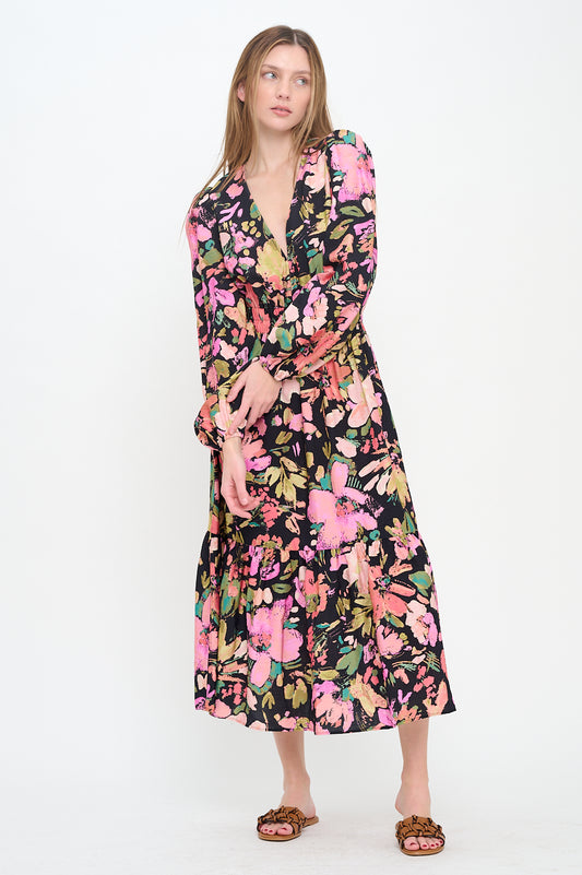 Model wearing the Midnight Garden Long Sleeve Maxi Dress, a black floral print maxi dress with a V-neck, long sleeves, and shoulder cut-outs.