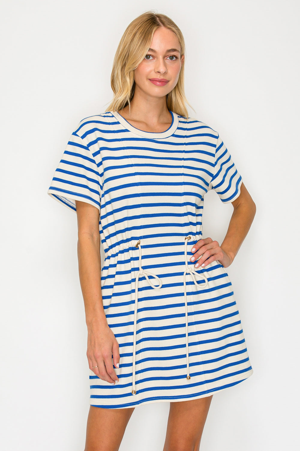 Woman wearing a blue and white striped dress on a white background