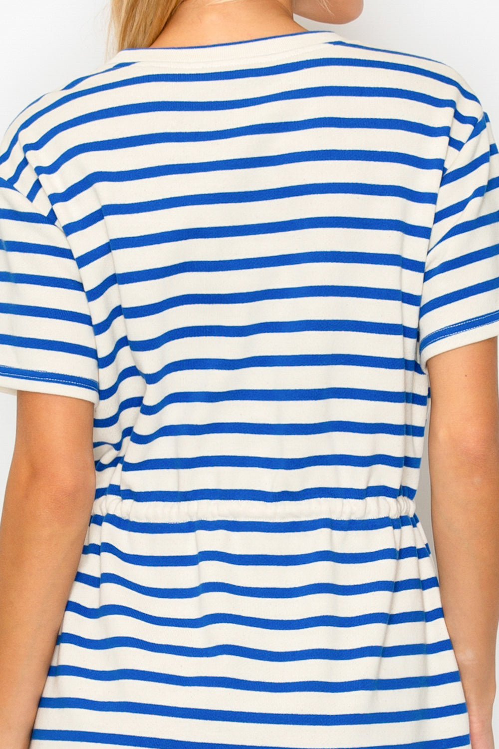Blue and white striped dress worn by a person on a plain background