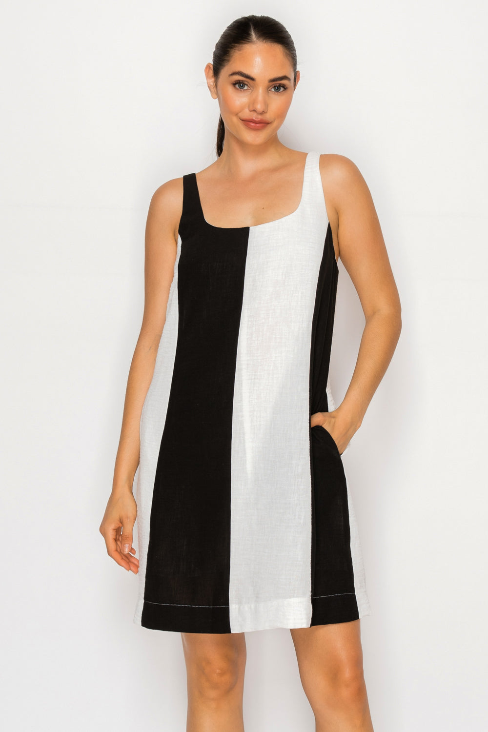 Model wearing the Black White Linen Short Dress, a color-block mini dress with a square neckline and side pocket.