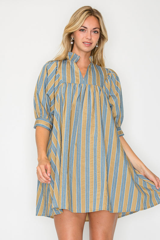 Model wearing the Hazel Fall Stripe Short Sleeve Dress, a blue and tan striped mini dress with a ruffle collar, puff sleeves, and a babydoll silhouette.