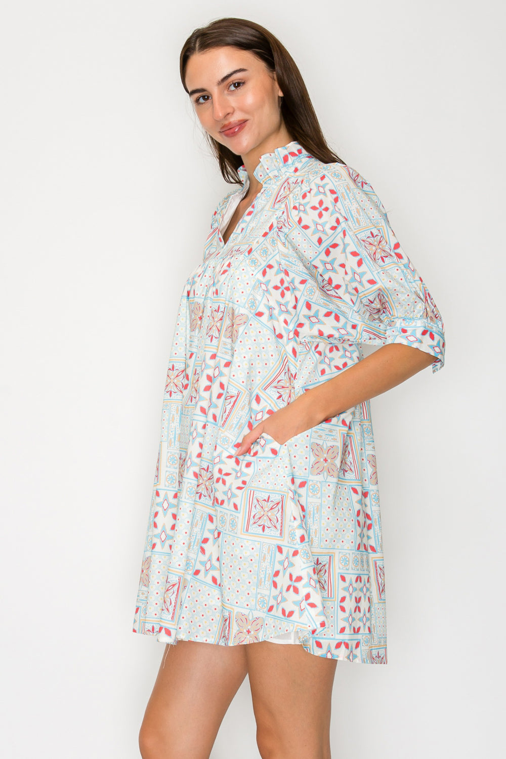 Woman wearing a floral dress against a white background