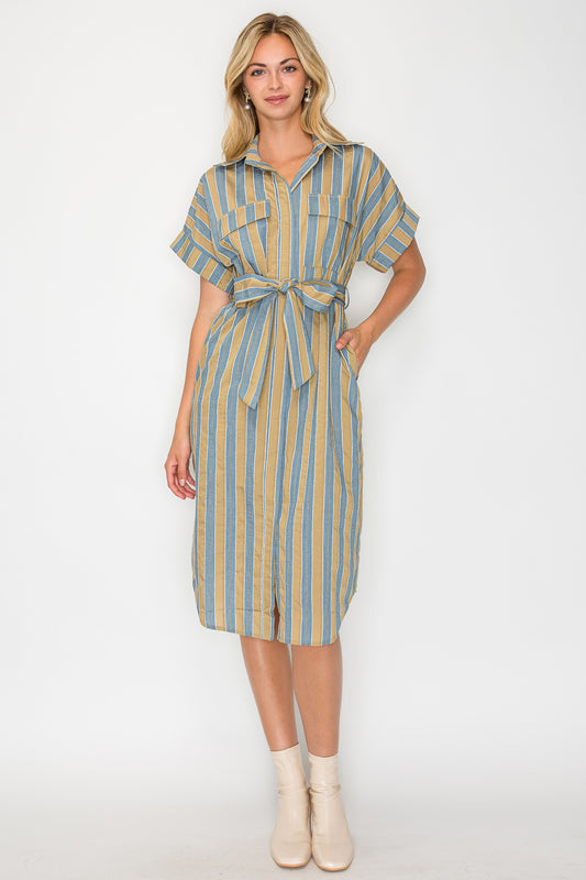 Model wearing the Hazel Fall Stripe Shirt Midi Dress, a blue and tan striped dress with a collar, tie-waist, and short sleeves.