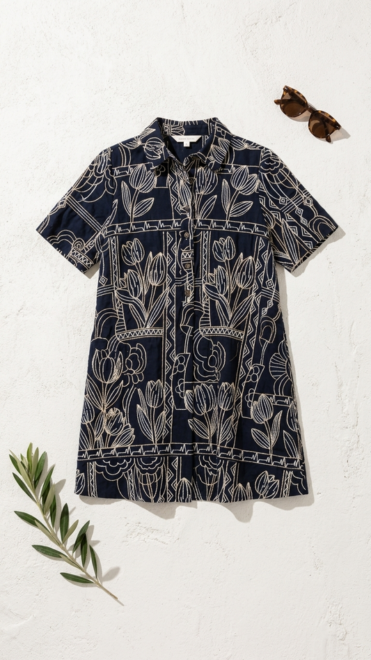 Navy dress with white floral pattern on a white background