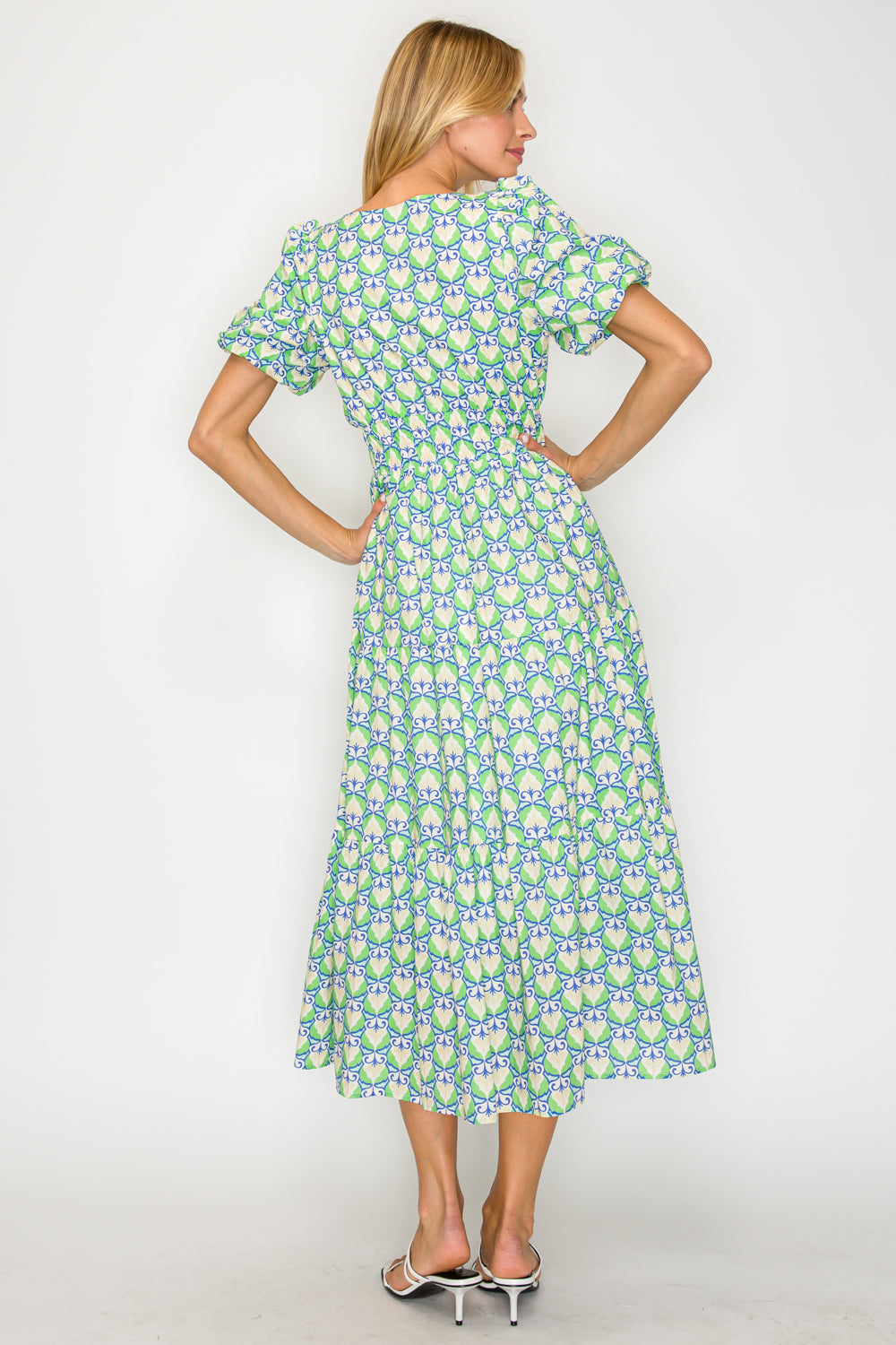 Woman wearing a floral dress with a white background
