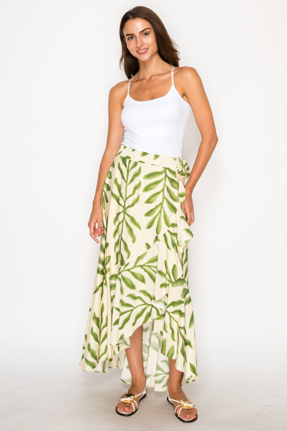 Model wearing the Olive Fern Skirt, a cream and green high-low wrap skirt with a ruffle hem