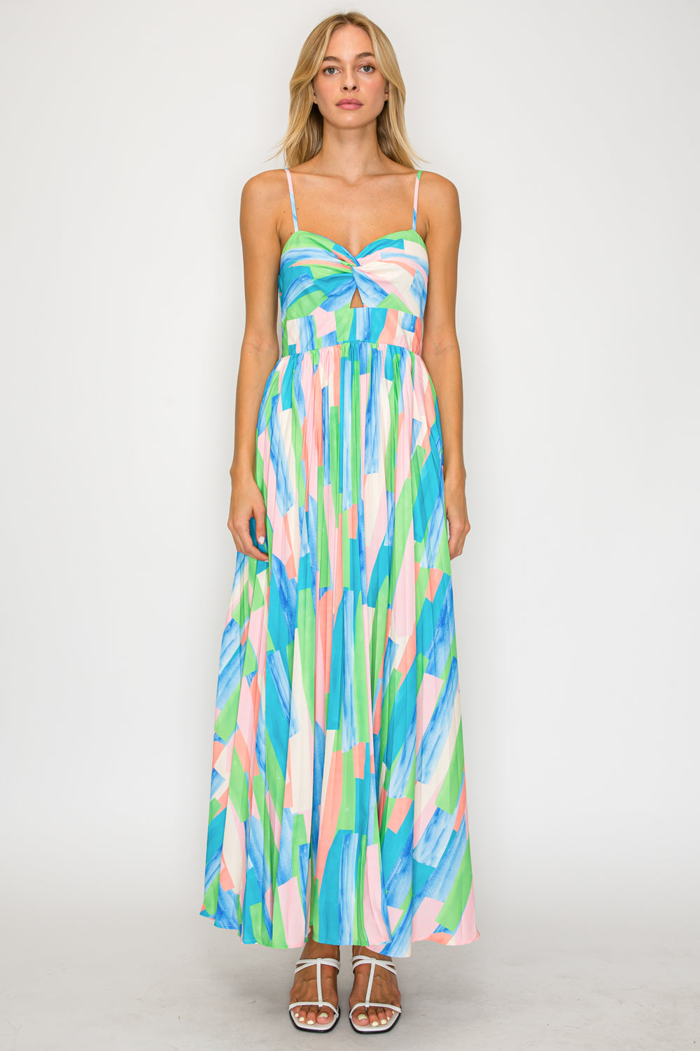 Woman wearing a colorful patterned dress on a plain background