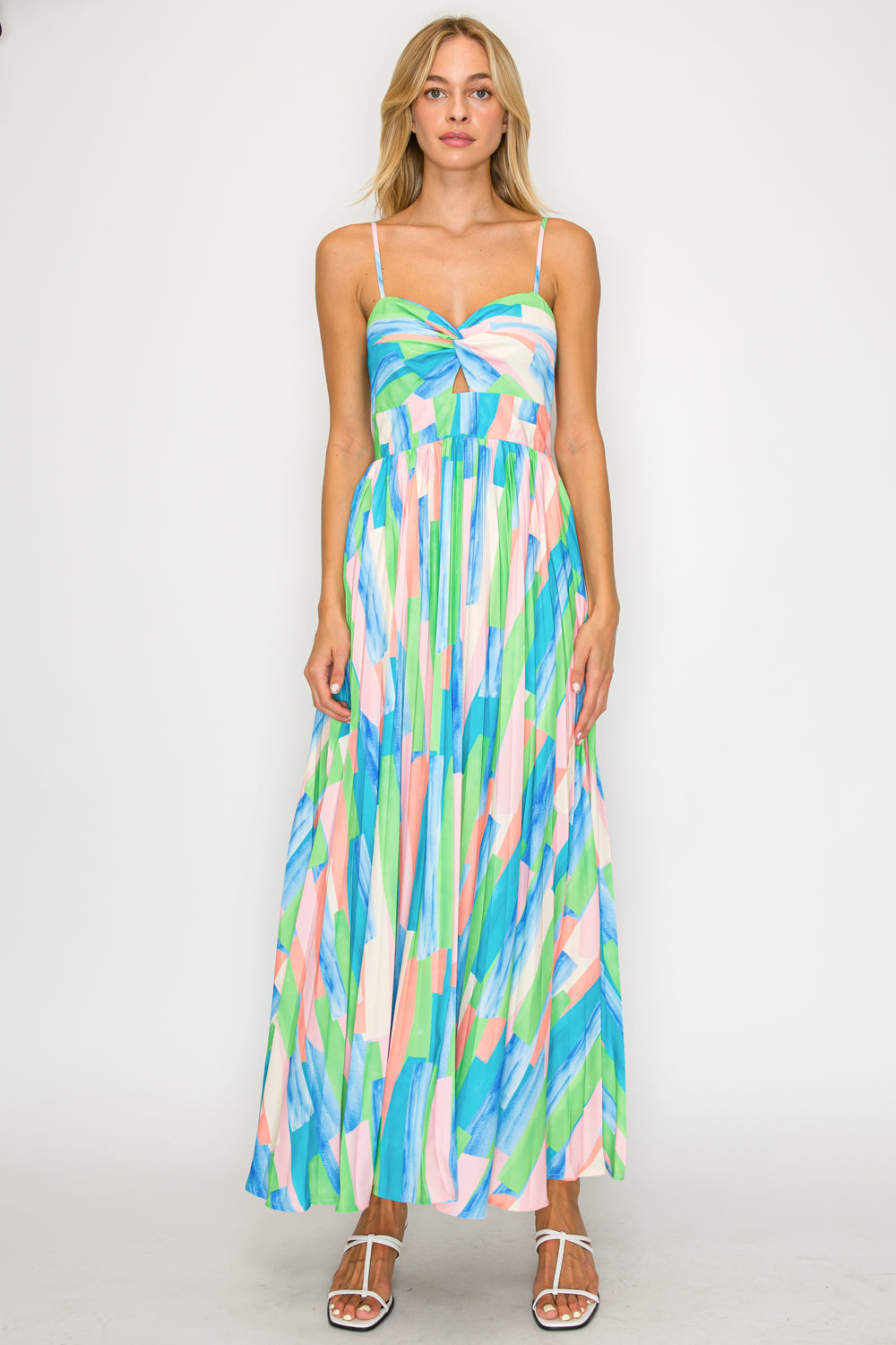 Woman wearing a colorful abstract patterned dress on a white background
