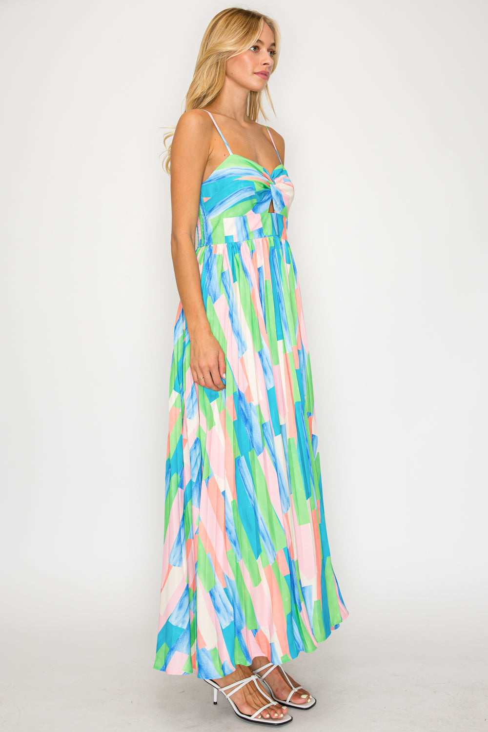 Woman wearing a colorful striped dress on a white background