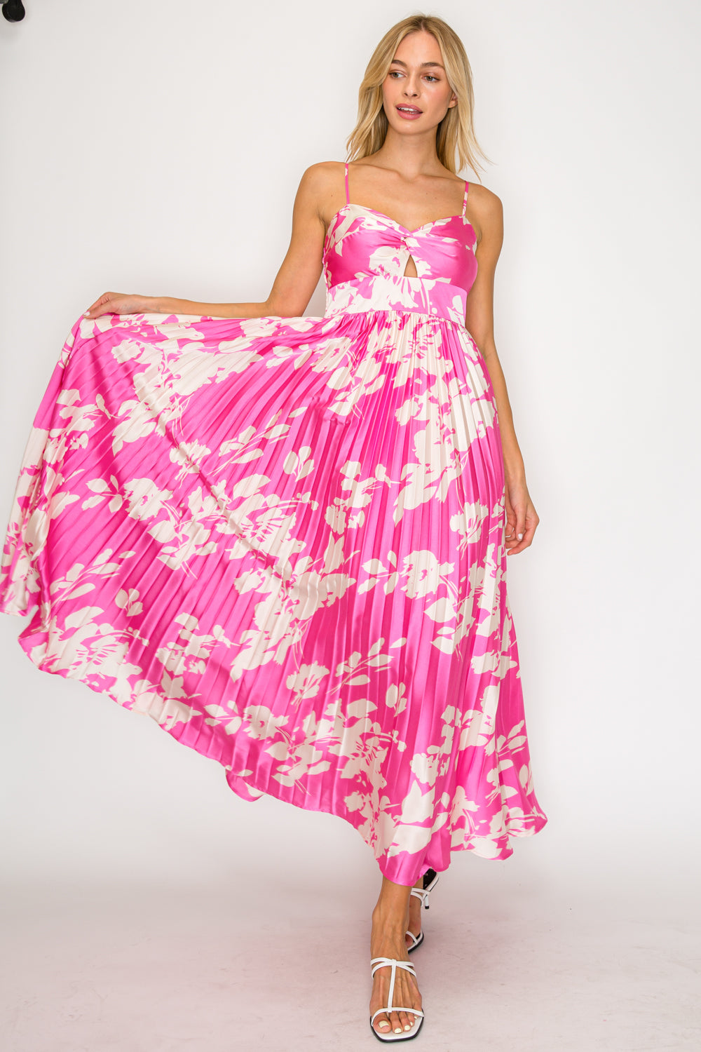 Woman wearing a pink floral dress on a white background