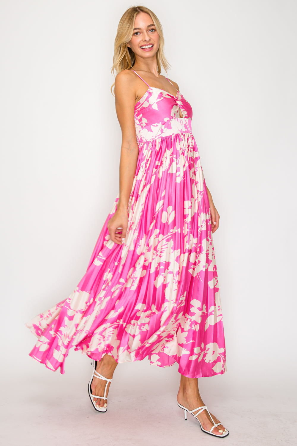 Woman wearing a pink floral dress on a white background