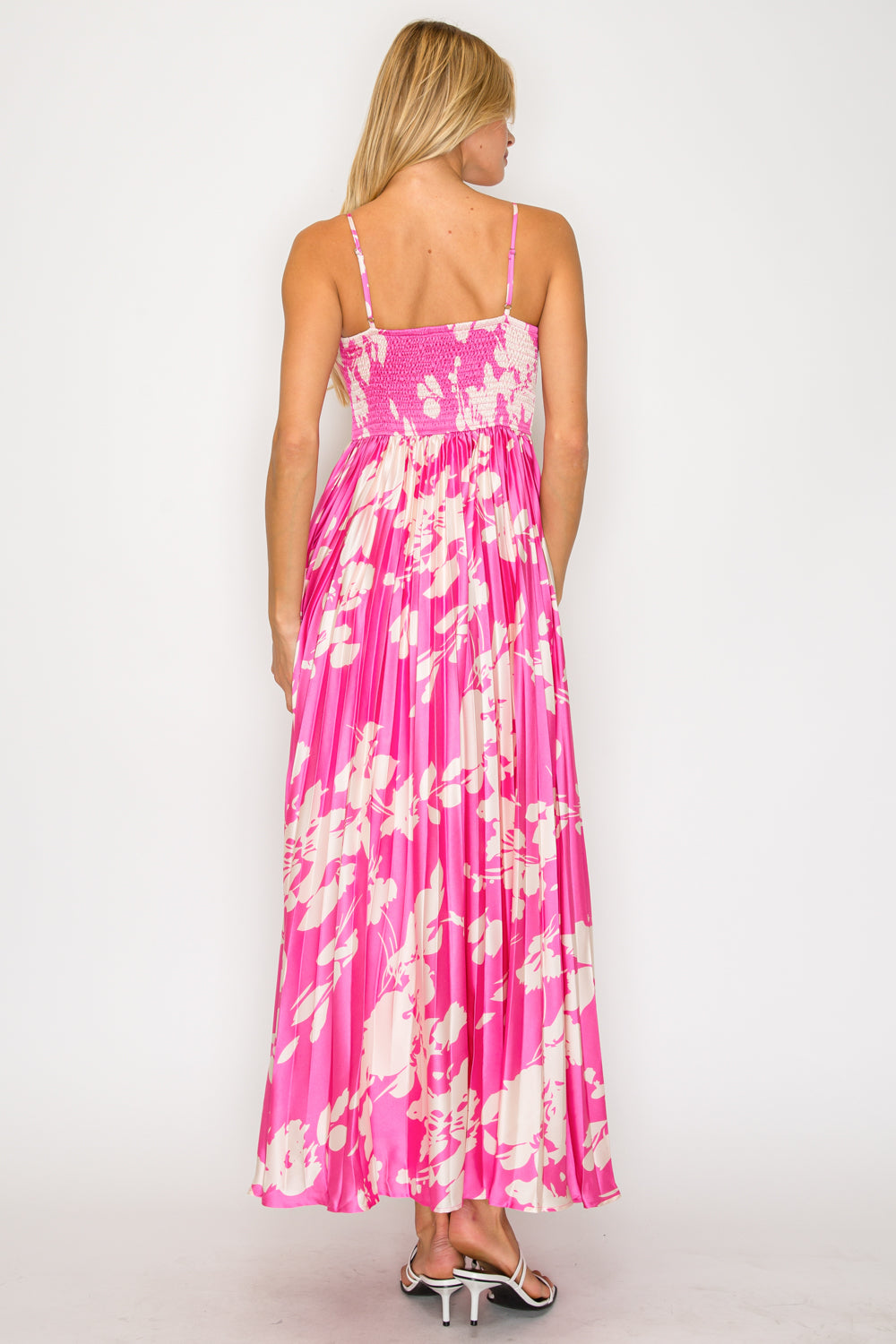 Woman wearing a pink floral dress on a white background