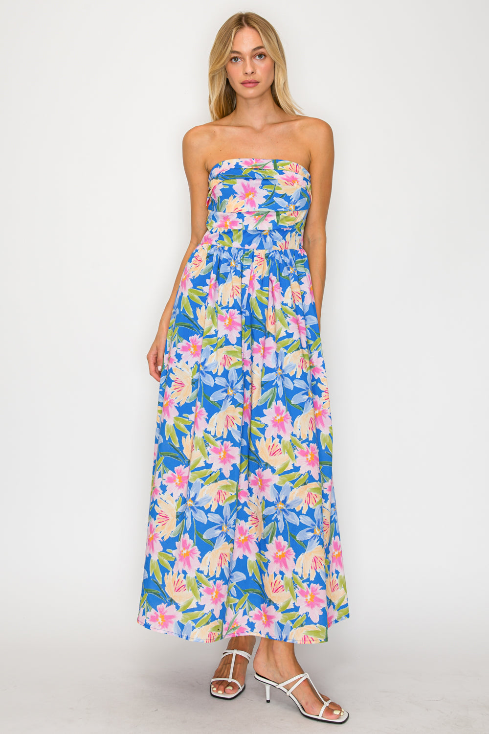 Woman wearing a strapless floral dress on a white background