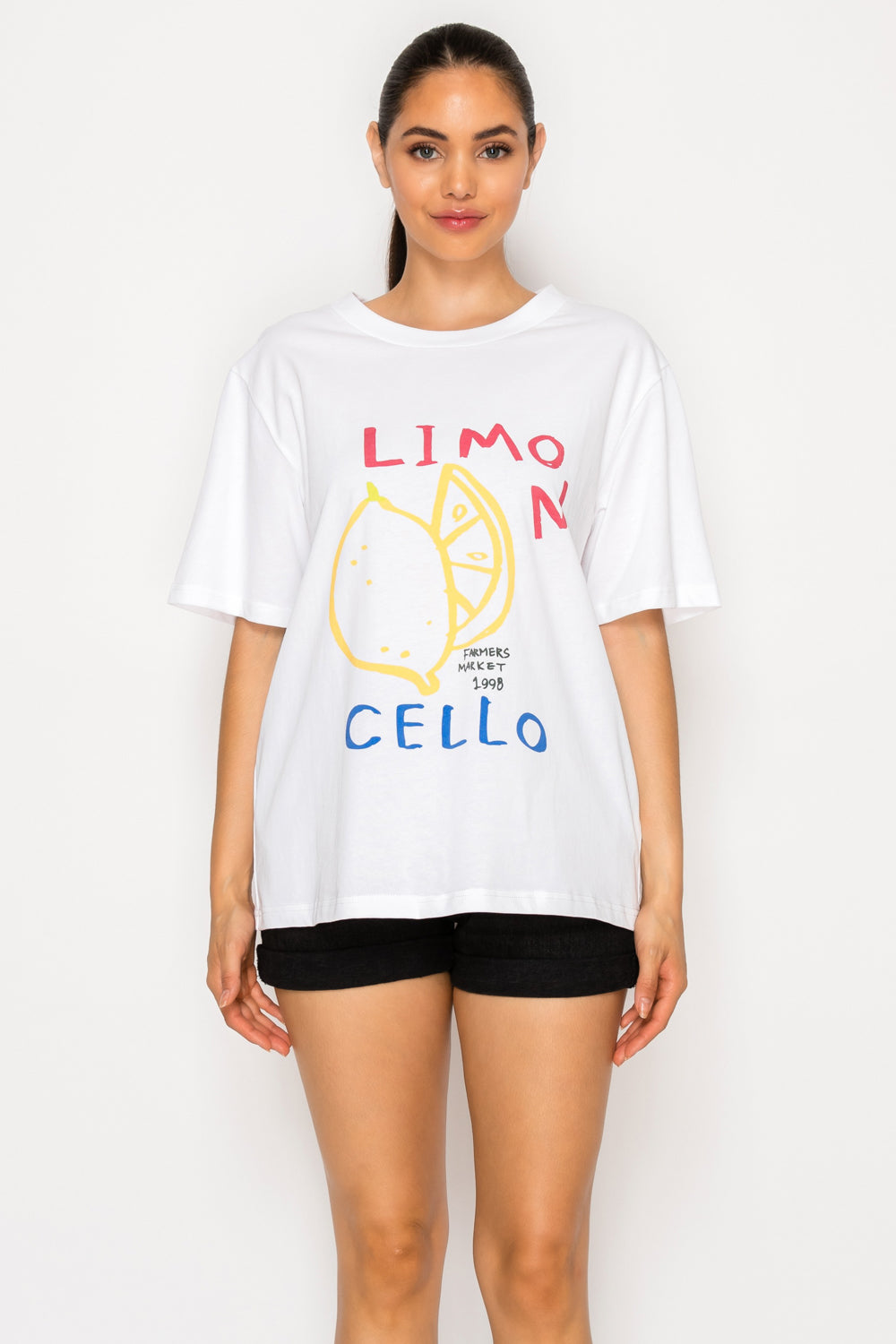 Model wearing the white Limoncello graphic t-shirt from Meet Me in Santorini.